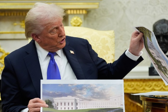 President Donald Trump holding artist renderings of the new White House ballroom.