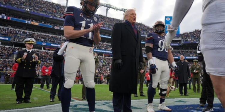 Trump takes the field at Army-Navy game for coin toss, military flyover