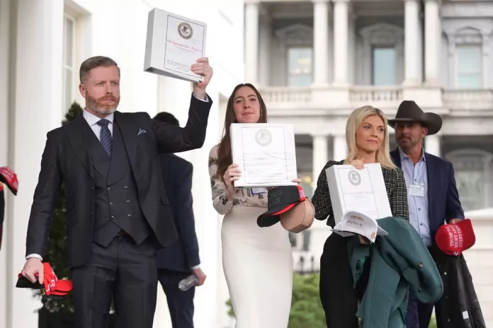 Conservative political commentator Rogan O'Handley, also known as DC Draino, social media content creator Chaya Raichik, and conservative political commentator Liz Wheeler hold up binders titled "The Epstein Files: Phase 1," with Jack Posobiec at the White House.