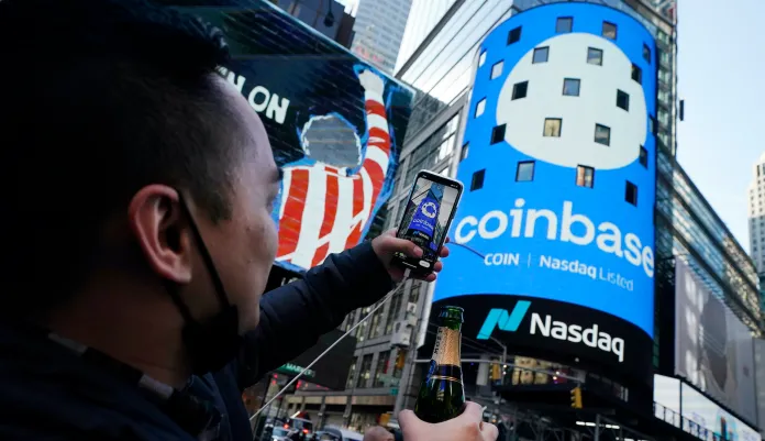 Coinbase employee Daniel Huynh takes photographs outside the Nasdaq MarketSite.