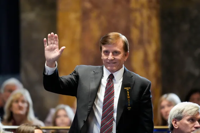 FILE - Louisiana State Treasurer John Fleming, waves as he is introduced during the swearing in of the Louisiana state legislature in Baton Rouge, La., Jan. 8, 2024.