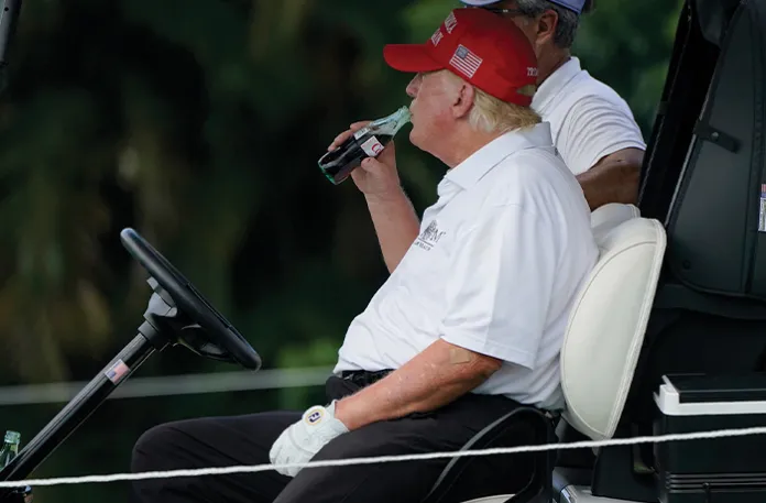 President Donald Trump drinks a Diet Coke during the ProAm of the LIV Golf Team Championship at Trump National Doral Golf Club in Doral, Florida. (Lynne Sladky/AP)