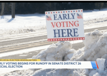 An early voting sign in the snow on election day.