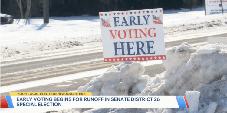 An early voting sign in the snow on election day.