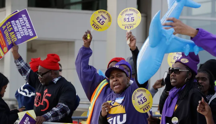 SEIU union members protest for an increase in the minimum wage. SEIU fired one of the lead architects of its $15 minimum wage campaign, stating that he violated the union's ethics rules regarding nepotism. (AP Photo/Carlos Osorio)