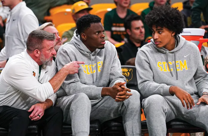 James Nnaji, center, sits court side on the bench in his first game with the Baylor Bears against the Arlington Baptist Patriots on Dec. 29 in Waco, Texas. (Jake Schroeder/Baylor Athletics)