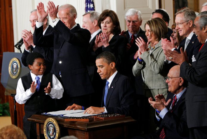 In this March 23, 2010, photo, President Barack Obama is applauded after signing the Affordable Care Act into law in the East Room of the White House in Washington. (AP Photo/Charles Dharapak, File)
