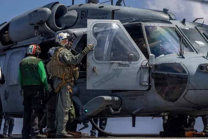 Capt. Daniel Keeler as he prepares to fly an MH-60R Sea Hawk helicopter.