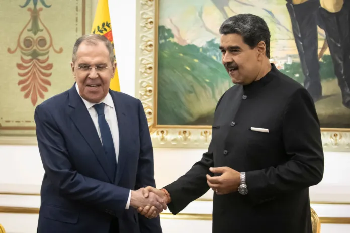 Nicolas Maduro, Venezuela's president, right, shakes hands with Sergei Lavrov, Russia's foreign minister, during a meeting at Miraflores Palace in Caracas, Venezuela, on Tuesday, Feb. 20, 2024. Russia and Venezuela agreed to broaden their oil production cooperation, Russia's Lavrov said from Caracas. Photographer: Carlos Becerra/Bloomberg via Getty Images Photographer: Carlos Becerra/Bloomberg via Getty Images