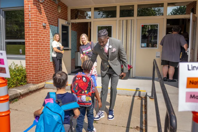 Des Moines Public Schools Superintendent Ian Roberts greets students at Mitchell Early Learning Center.