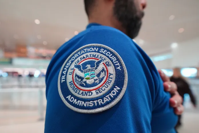 A TSA agent wears a U.S. Department of Homeland Security patch on their uniform at Love Field Airport, in Dallas, Wednesday, Feb. 18, 2026
