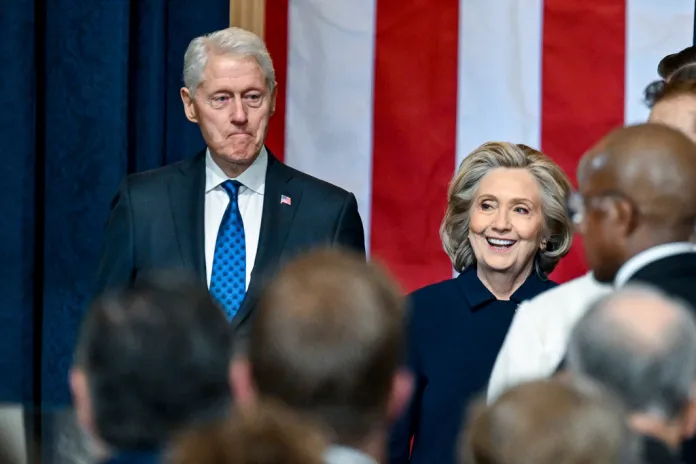 Former Secretary of State Hillary Clinton, right, and former President Bill Clinton arrive before the 60th Presidential Inauguration in the Rotunda of the U.S. Capitol.