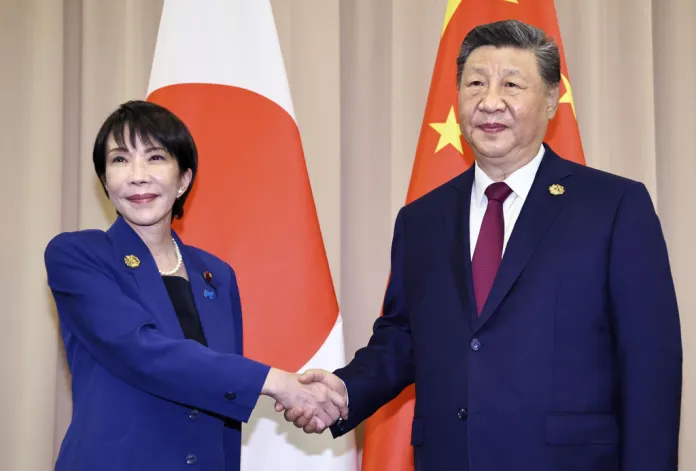 Takaichi shakes hands with Xi