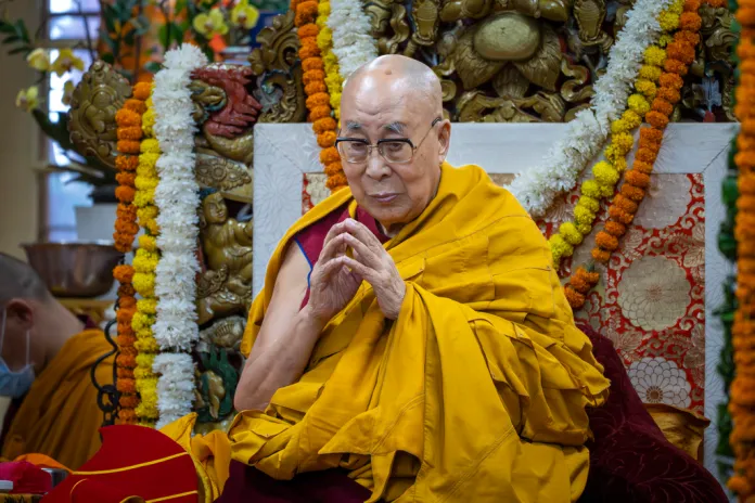 Dalai Lama leads prayer at an event in India