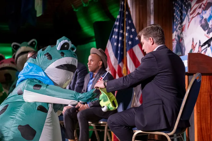 CNN broadcaster Jim Acosta accepts an American flag from a Portland Frog Brigade member before moderating a panel at the State of the Swamp event in Washington, D.C., on Feb. 24. (Riley Harty / ZUMA Press Wire via Newscom)
