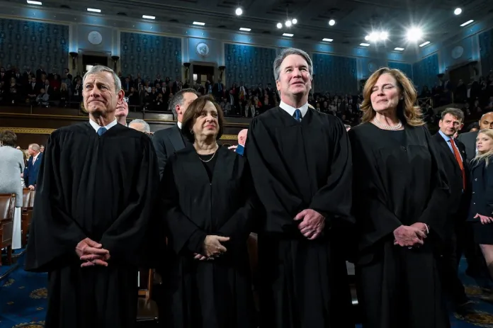 From left, Chief Justice John Roberts, Justice Elena Kagan, Justice Brett Kavanaugh and Justice Amy Coney Barrett stand before President Donald Trump delivers the State of the Union address to a joint session of Congress in the House chamber at the U.S. Capitol in Washington, Tuesday, Feb. 24, 2026. (Kenny Holston/The New York Times via AP, Pool)