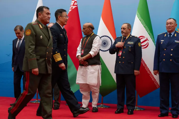 Chinese defense minister and Iranian defense minister walk shoulder-to-shoulder 