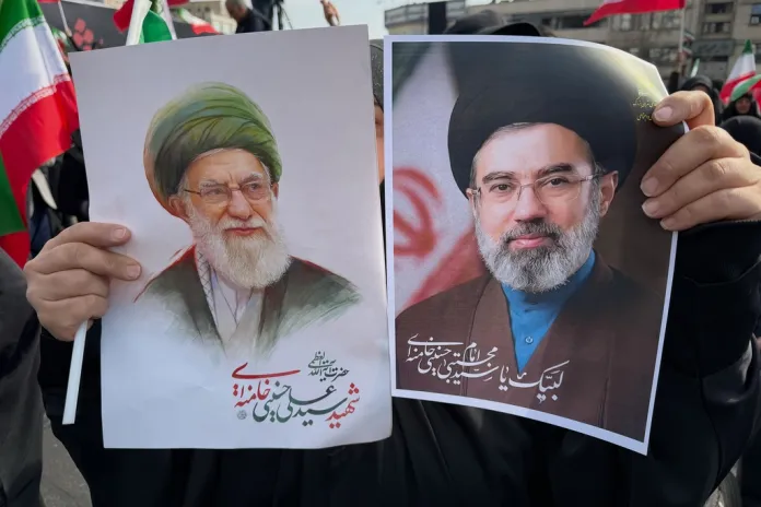 Portraits printed on paper show both Khameneis side by side