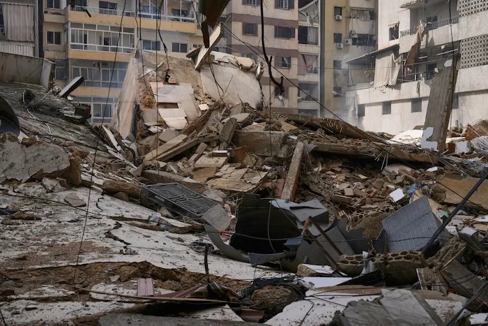 Debris litters a street from buildings damaged in an Israeli airstrike in Dahiyeh.