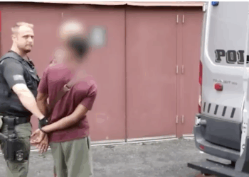 A U.S. law enforcement officials arrests a foreign national.