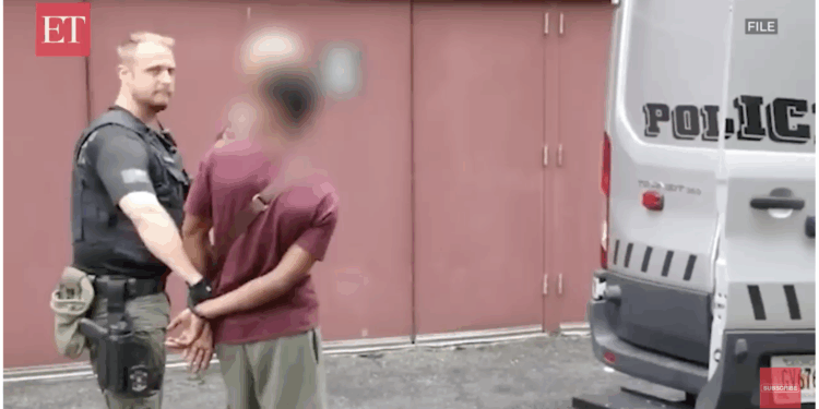 A U.S. law enforcement officials arrests a foreign national.