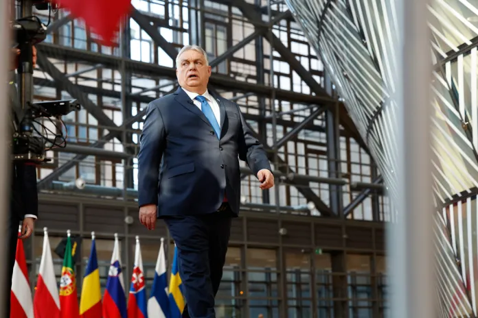 Orban walks at the entrance of the European Summit