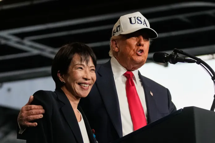 Trump puts his hand around Takaichi's shoulder on-stage