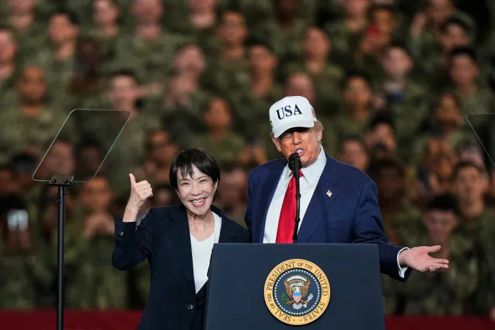 Japanese Prime Minister Sanae Takaichi gestures as U.S. President Donald Trump delivers speech.