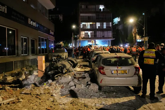 Israeli security forces inspect the site of an Iranian missile strike that killed two people in Ramat Gan, Israel, Wednesday, March 18, 2026. (AP Photo/Ohad Zwigenberg)