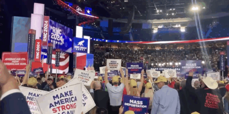 Attendees at RNC Convention hold 'Mass Deportations Now' signs