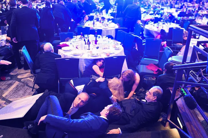 WASHINGTON, DC - APRIL 25: Guests take cover after a un-kown safety event took place as President Donald Trump was to speak to attendees of the annual White House Correspondents Association Dinner April 25, 2026 in Washington, DC. According to reports, President Donald Trump, along with other government officials, were evacuated from the Washington Hilton after what sounded like gun fire. (Photo by Nathan Howard/Getty Images)